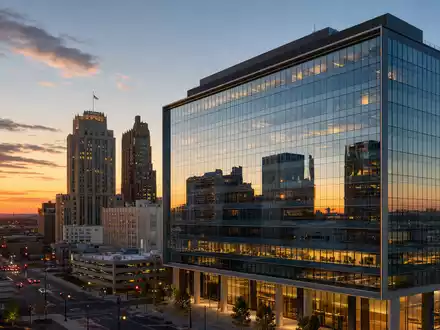 Prudential Financial US7443201022 zeigt fotorealistisch ein modernes Bürohochhaus in Newark bei goldenem Sonnenuntergang - Foto: THN