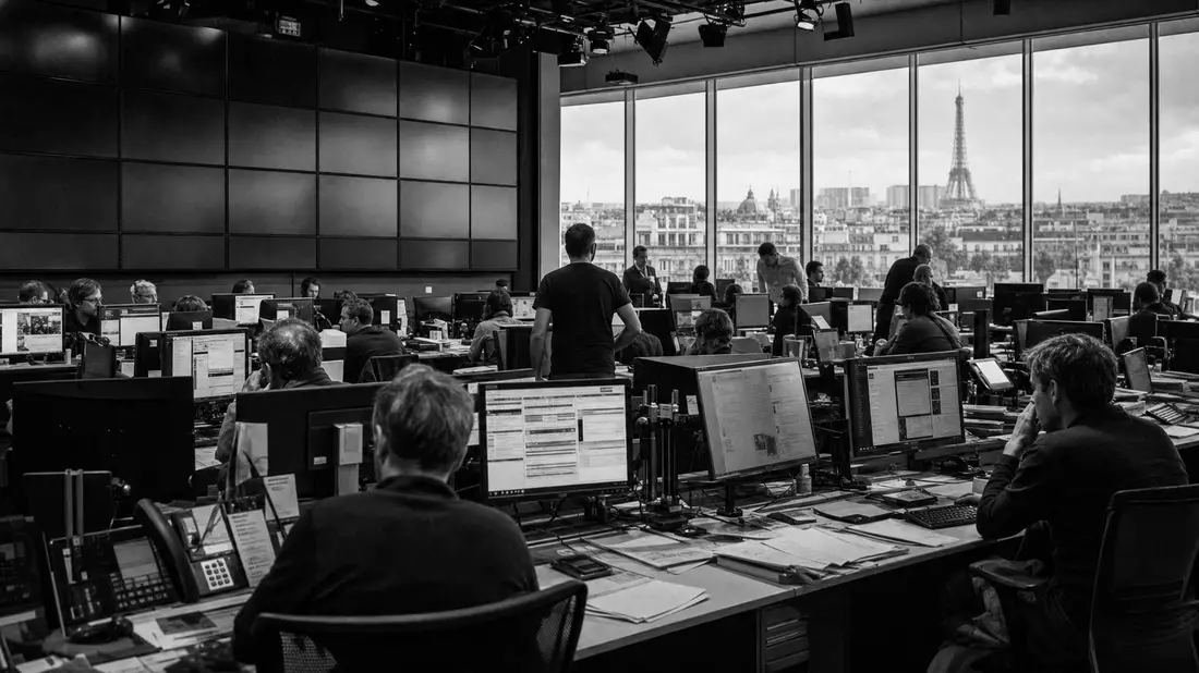Schwarzweiß-Reportagefoto einer Newsroom-Redaktion mit Blick auf Paris