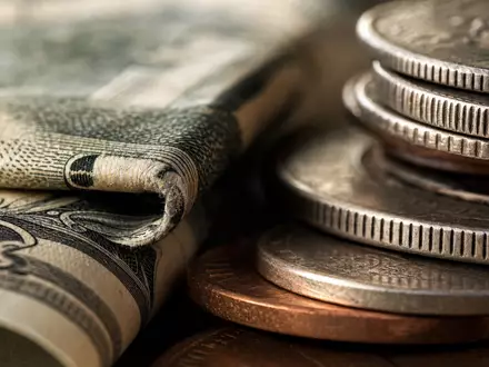 Makroaufnahme von Banknoten und Münzen visualisiert die Branche der Morgan Stanley Aktie ISIN US6174464486 - Foto: THN