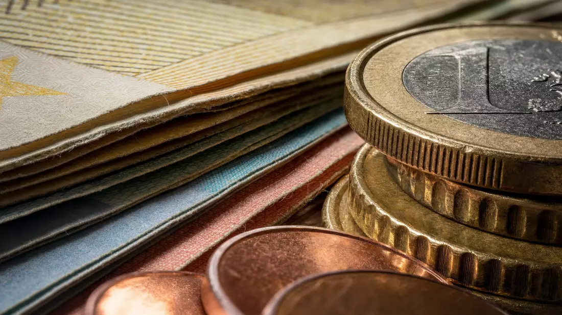 Makrofoto von gestapelten Euro-Münzen und Banknoten mit feiner Texturdetail