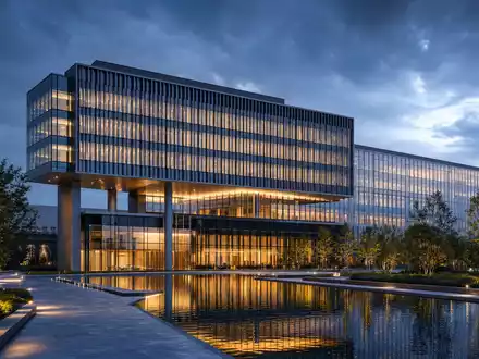 The Trade Desk (US88339J1051) zeigt Architektur-Render eines gläsernen Technologie-Hauptsitzes am Abend mit Teich - Foto: THN