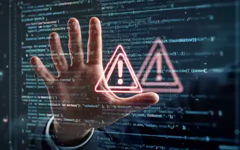 Eine Hand versucht, eine digitale Oberfläche mit Code und Warnsymbolen zu blockieren, was KI und Arbeitsplatzunsicherheit symbolisiert. - Foto: über boerse-global.de