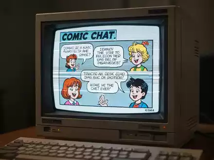 Ein alter Computermonitor aus den 1990ern zeigt die bunte, comicartige Oberfläche von Microsoft Comic Chat. - Foto: über boerse-global.de