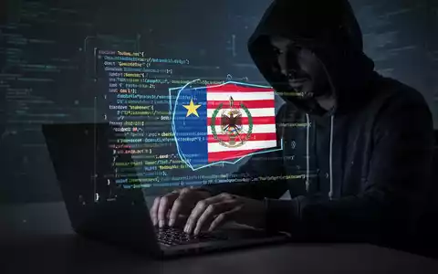 Eine Person mit Kapuzenpullover arbeitet an einem Laptop, darüberliegend Codezeilen und ein SVG-Symbol einer Flagge, das auf Malware hindeutet. - Foto: über boerse-global.de