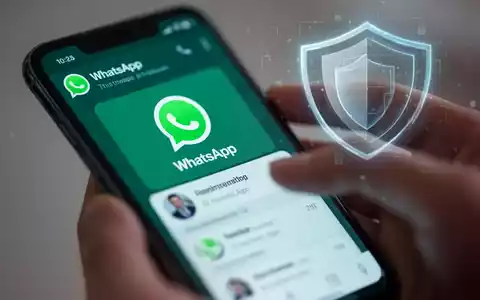 Ein Smartphone zeigt die WhatsApp-Benutzeroberfläche, während Hände damit interagieren, mit einem digitalen Schutzschild im Hintergrund. - Foto: über boerse-global.de