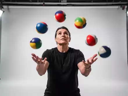 Eine Person beim Jonglieren zur Förderung der kognitiven Fitness in einem hellen Studio. - Foto: über boerse-global.de