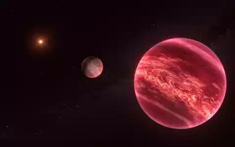 Künstlerische Darstellung des Systems um den Stern CD-35 2722. Das System besteht aus einem Stern, einem Braunen Zwerg und einem Satelliten. - Foto: M. Kornmesser/ESO/dpa