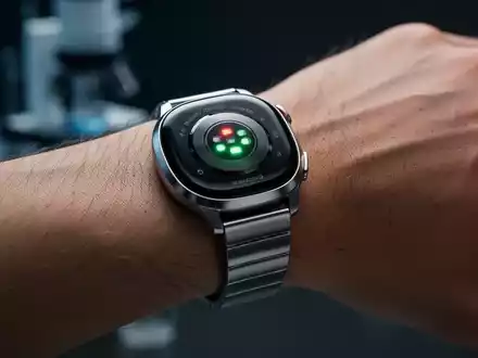 Nahaufnahme einer modernen Smartwatch am Handgelenk, die KI-gestützte Gesundheitsdaten in einem professionellen Umfeld anzeigt. - Foto: über boerse-global.de