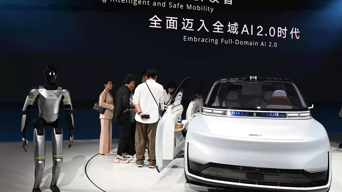 Hier präsentiert Geely ein Auto samt humanoidem Roboter auf einer Automesse in Peking. Nun wagt die Firma den Sprung nach Spanien, um dort Autos zu bauen.  - Bild: Johannes Neudecker/dpa