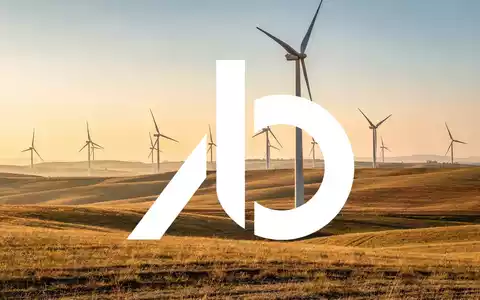 Moderne Windkraftanlagen in einer weiten Landschaft bei Sonnenaufgang als Symbol für den Ausbau erneuerbarer Energien. - Foto: über boerse-global.de