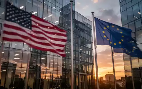 Flaggen der USA und der EU spiegeln sich in der Glasfassade eines modernen Bürogebäudes. - Foto: über boerse-global.de
