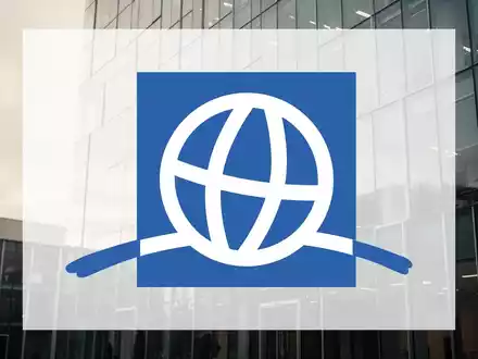 Moderne Glasfassade eines Bürogebäudes bei bewölktem Himmel als Symbol für wirtschaftliche Zurückhaltung. - Foto: über boerse-global.de