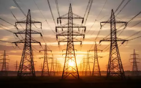 Hochspannungsleitungen und Strommasten in der Abendsonne als Symbol für die steigenden Stromnetzgebühren. - Foto: über boerse-global.de