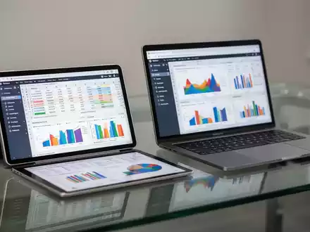 Tablet und Laptop mit komplexen Daten-Tabellen und Diagrammen auf modernem Bürotisch. - Foto: über boerse-global.de