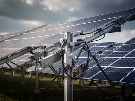Reihen von Solarmodulen in einem Solarpark bei bewölktem Himmel. - Foto: über boerse-global.de