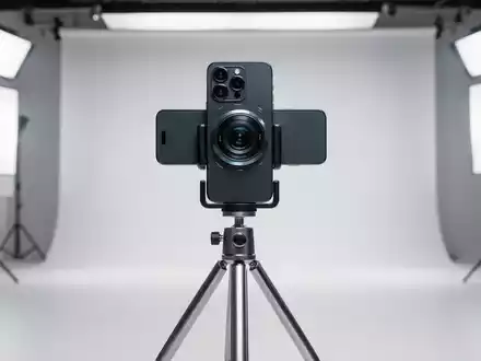 Ein modernes Smartphone auf einem Stativ in einem professionellen Fotostudio, bereit für Aufnahmen. - Foto: über boerse-global.de