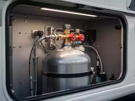 Sicherheitsgeprüfte Gastankflasche in einem Wohnmobil mit Fokus auf die technische Installation und Sicherheitsventile. - Foto: über boerse-global.de