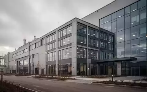 Modernes Industriegebäude eines Produktionsstandorts an einem bewölkten Tag. - Foto: über boerse-global.de