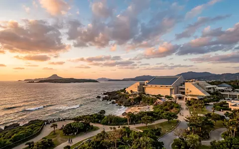 Fotorealistische Panoramaaufnahme von Churaumi-Aquarium Okinawa in Motobu Japan, warmes Abendlicht auf Wahrzeichen - Foto: THN