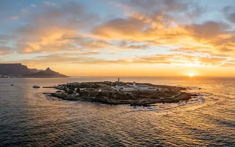 Fotorealistische Panoramaaufnahme von Robben Island in Kapstadt Sudafrika, warmes Abendlicht auf Wahrzeichen - Foto: THN