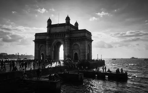 Schwarzweiss-Reportagebild vom Wahrzeichen Gateway of India Mumbai in Mumbai Indien, dokumentarische Reisefotografie mit starken Kontrasten - Foto: THN