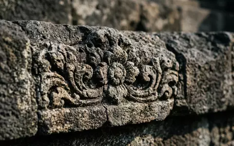 Extreme Makroaufnahme eines Materialdetails am Wahrzeichen Borobudur in Magelang Indonesien, taktile Struktur und weiches Seitenlicht - Foto: THN