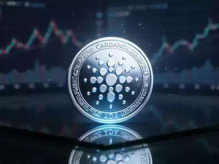 Digitales Cardano-Symbol auf einer glänzenden Oberfläche mit unscharfen Finanzdiagrammen im Hintergrund. - Foto: über boerse-global.de