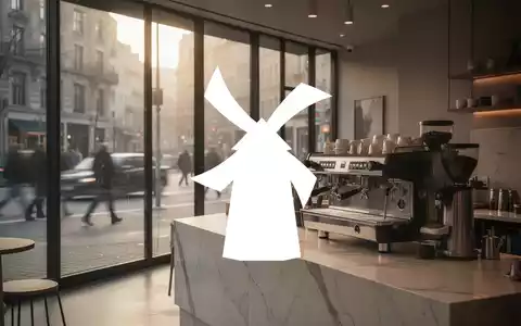 Modernes Café-Interieur in der Morgendämmerung mit Fokus auf eine hochwertige Espressomaschine und urbaner Atmosphäre. - Foto: über boerse-global.de