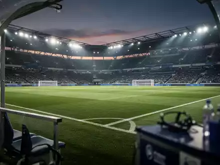 Ein moderner Fußballplatz in einem Stadion bei Dämmerung, der die professionelle Atmosphäre des Profifußballs vermittelt. - Foto: über boerse-global.de