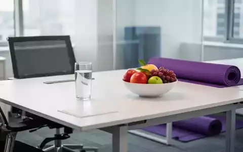 Ein heller, moderner Arbeitsplatz mit frischem Obst und einer Yogamatte als Symbol für Gesundheit und Vereinbarkeit. - Foto: über boerse-global.de