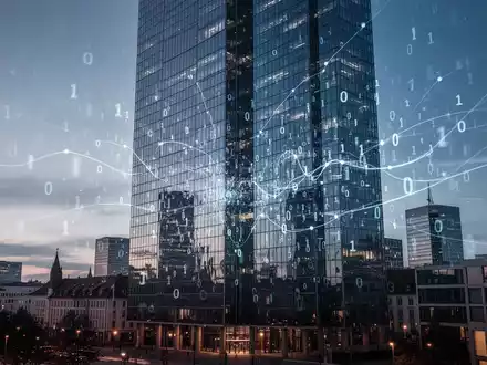Ein modernes deutsches Stadtbild mit einem gläsernen Wolkenkratzer, der digitale Datenströme und Netzwerke reflektiert. - Foto: über boerse-global.de