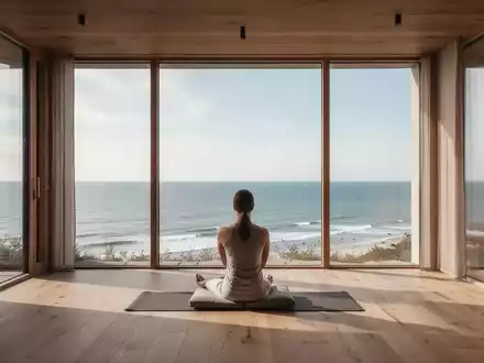 Ein minimalistischer, heller Meditationsraum mit Blick auf die Küste Schleswig-Holsteins bei sanftem Tageslicht. - Foto: über boerse-global.de