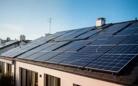 Moderne Solaranlagen auf einem Hausdach unter blauem Himmel als Symbol für die Energiewende und Netzentgelte. - Foto: über boerse-global.de