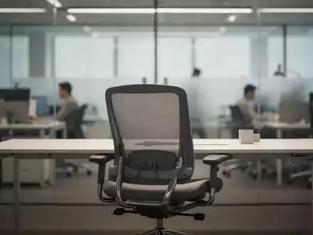 Ein leerer Büroarbeitsplatz mit einem ergonomischen Stuhl vor dem Hintergrund eines modernen, verschwommenen Büros. - Foto: über boerse-global.de