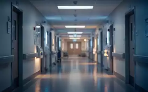 Ein minimalistischer, unscharfer Krankenhausflur mit atmosphärischer Beleuchtung, der die angespannte Lage im Gesundheitswesen symbolisiert. - Foto: über boerse-global.de