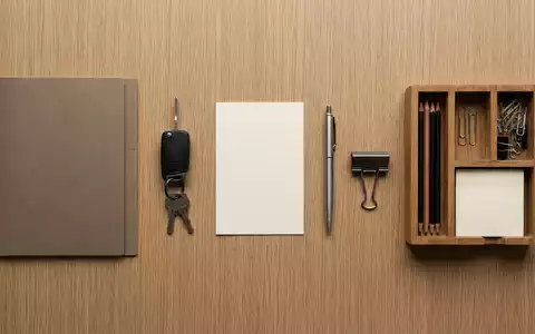 Flatlay-Arrangement rund um Versicherungsmappe zum Thema AXA KFZ-Versicherung, ISIN FR0000120628, weiches Oberlicht - Foto: THN