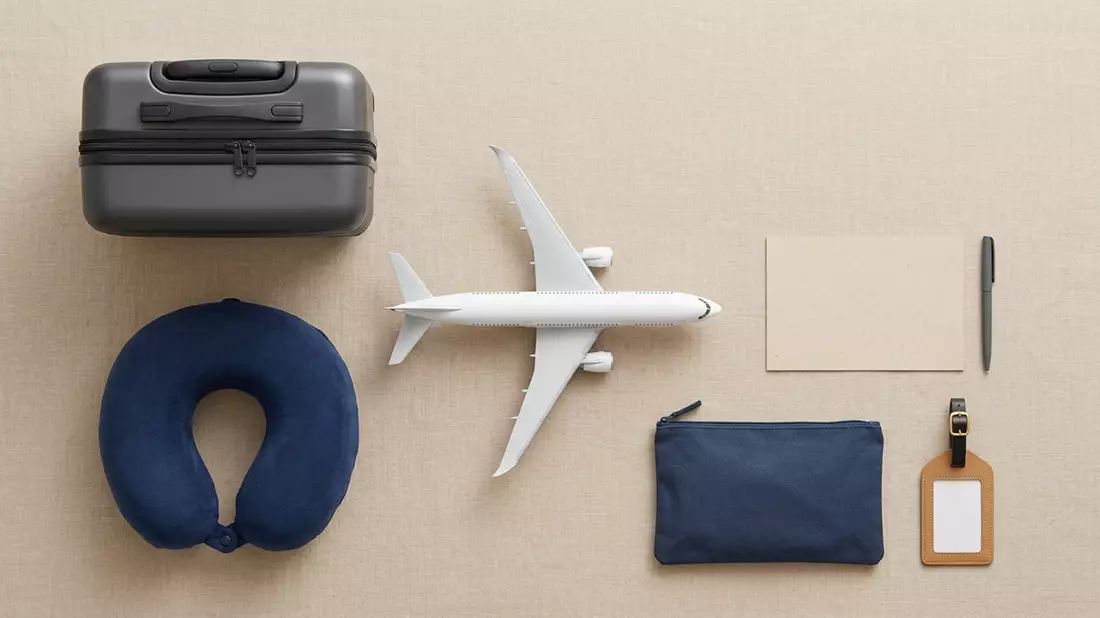 Flatlay-Arrangement rund um Passagierflugzeug mit passenden Requisiten von oben