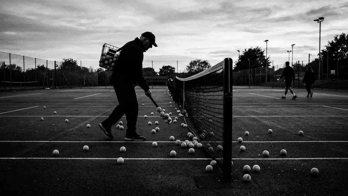 Schwarzweiss-Reportagebild mit Tennisbälle in dokumentarischer Arbeitsumgebung