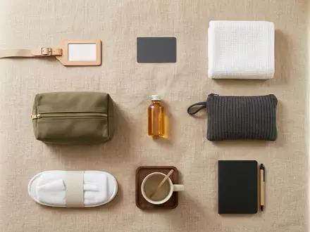 Flatlay-Arrangement rund um Hotelzimmer zum Thema Expedia Hotelbuchung, ISIN US30212P3038, weiches Oberlicht - Foto: THN