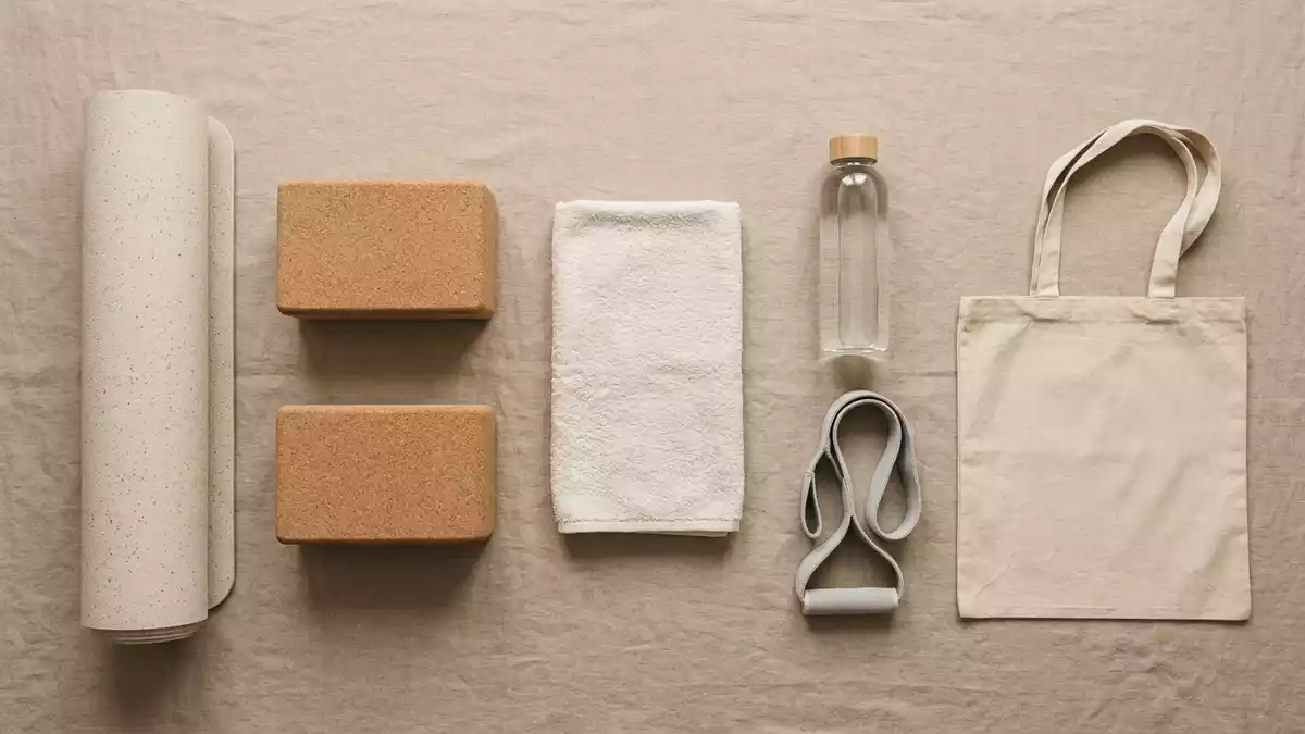 Flatlay-Arrangement rund um Yogamatte mit passenden Requisiten von oben, neutral