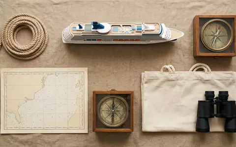 Flatlay-Arrangement rund um Kreuzfahrtschiff zum Thema Norwegian Prima, ISIN BMG667211046, weiches Oberlicht - Foto: THN
