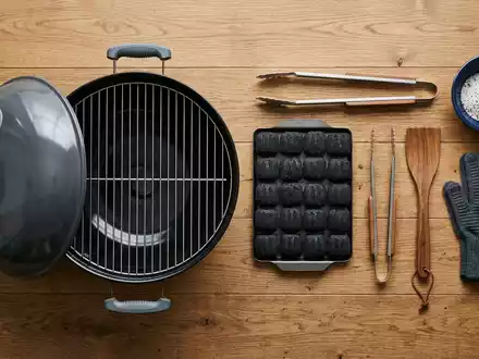 Flatlay-Arrangement rund um Kugelgrill zum Thema Weber Kugelgrill, ISIN US94770V1052, weiches Oberlicht - Foto: THN