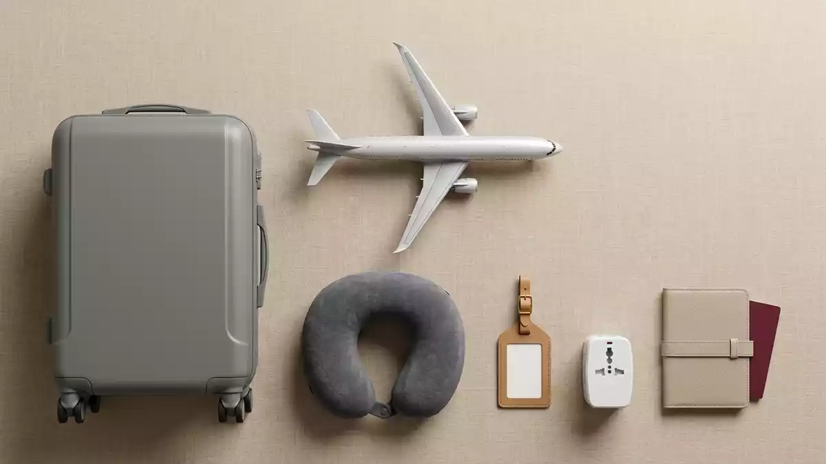 Flatlay-Arrangement rund um Passagierflugzeug mit passenden Requisiten von oben