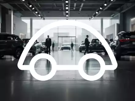 Abstraktes Bild eines modernen Autohauses mit verschwommenen Fahrzeugsilhouetten in stimmungsvollem Licht. - Foto: über boerse-global.de