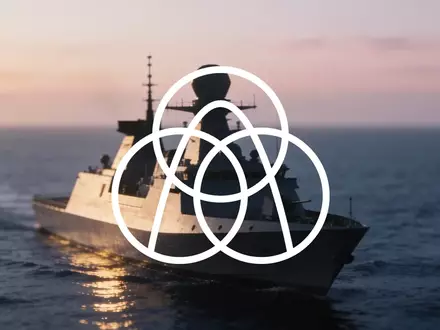 Silhouette eines modernen Marineschiffs auf ruhigem Wasser bei Dämmerung, symbolisiert industrielle maritime Technik. - Foto: über boerse-global.de