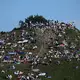 Erste Besucher bevölkern den Olympiaberg im Münchner Olympiapark, um von dort die partielle Sonnenfinsternis zu beobachten. - Bild: Felix Hörhager/dpa