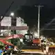 Helfer bringen einen Bagger zu einem eingestürzten Gebäude. - Bild: Philipp Znidar/dpa