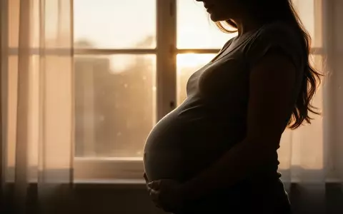 Nahaufnahme der Silhouette einer schwangeren Frau vor einem sonnendurchfluteten Fenster. - Foto: über boerse-global.de