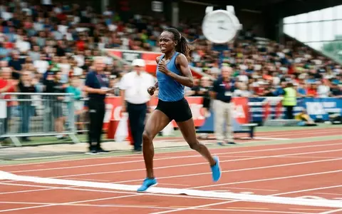 Ein Langstreckenläufer überquert bei einem Leichtathletik-Wettkampf die Ziellinie auf einer Stadionbahn. - Foto: über boerse-global.de