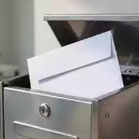 Ein weißer Geschäftsbrief liegt in einem Briefkasten, symbolisch für die rechtssichere Zustellung einer Kündigung. - Foto: über boerse-global.de